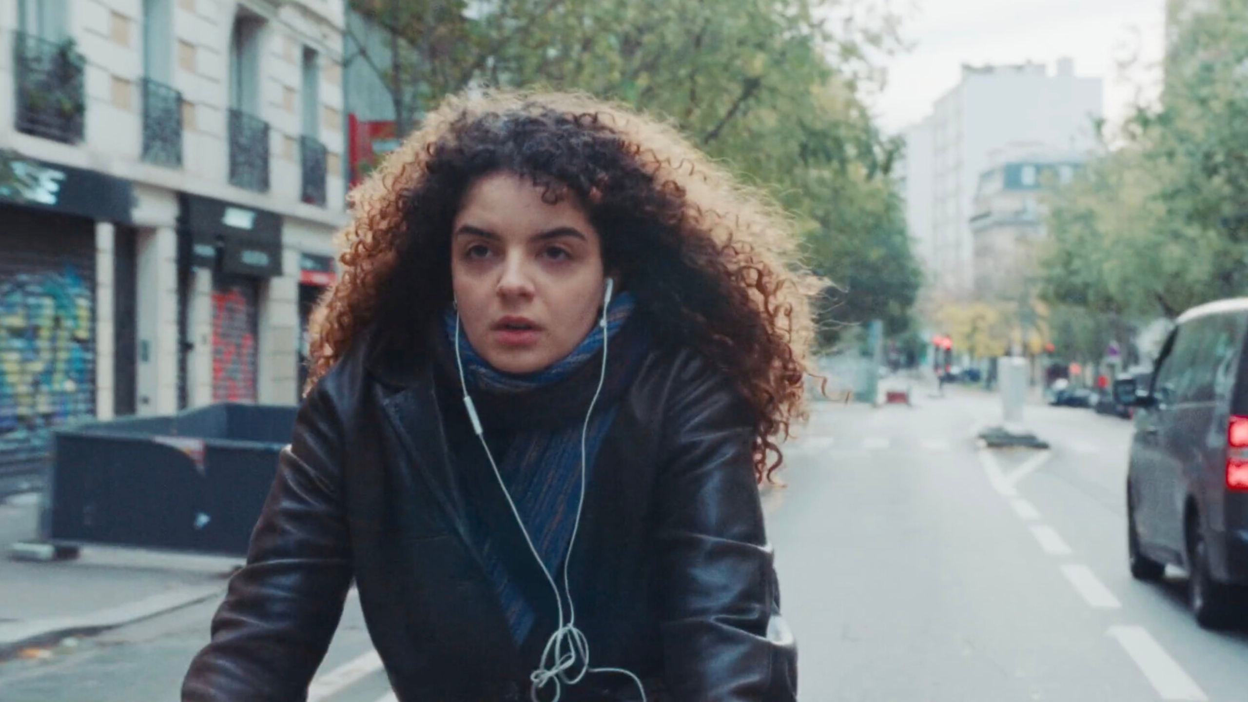 Farah is riding her bike through the streets of Paris, heading to meet her best friend to accompany her to an important appointment.